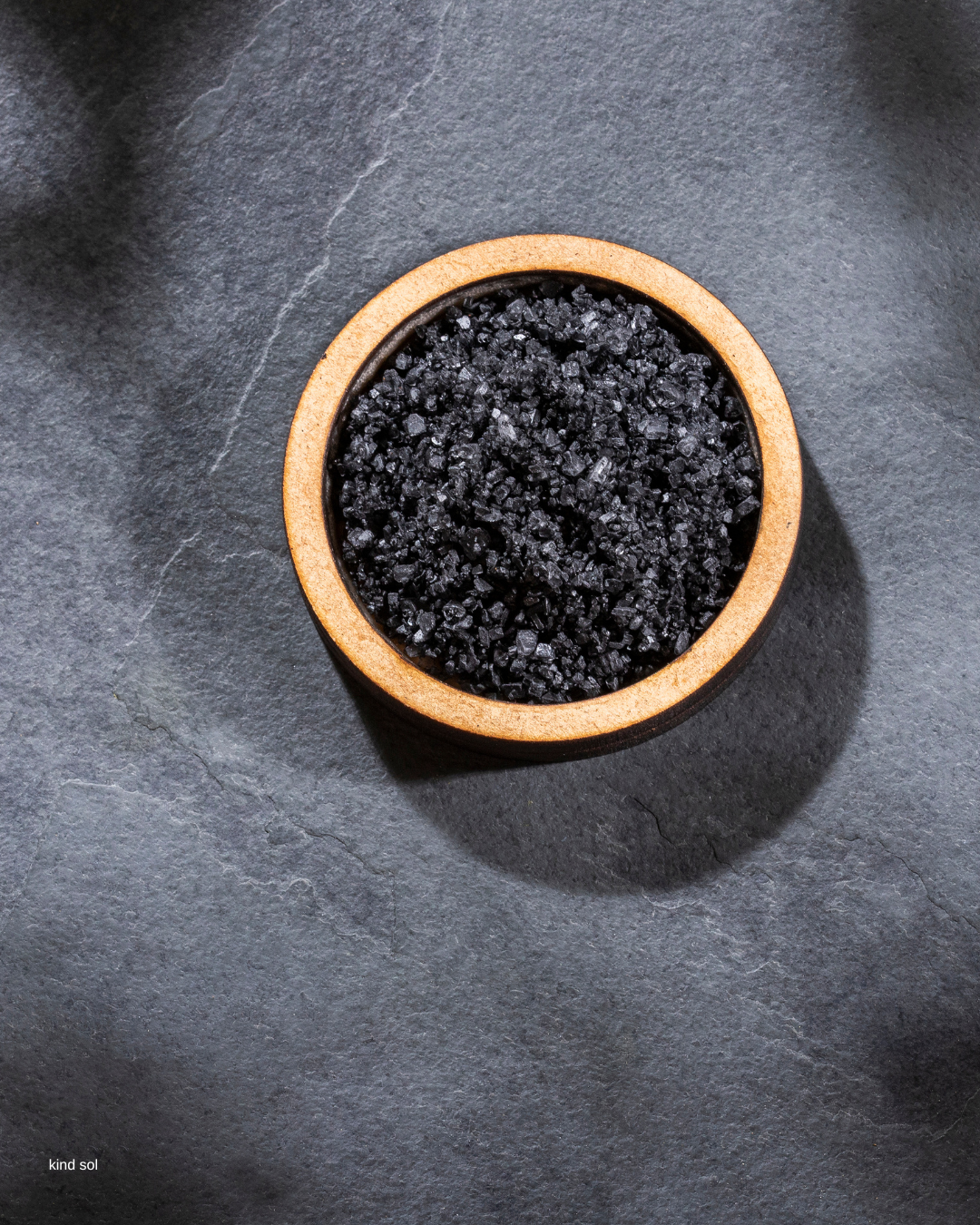 a bamboo bowl of black Hawaiian lava salt