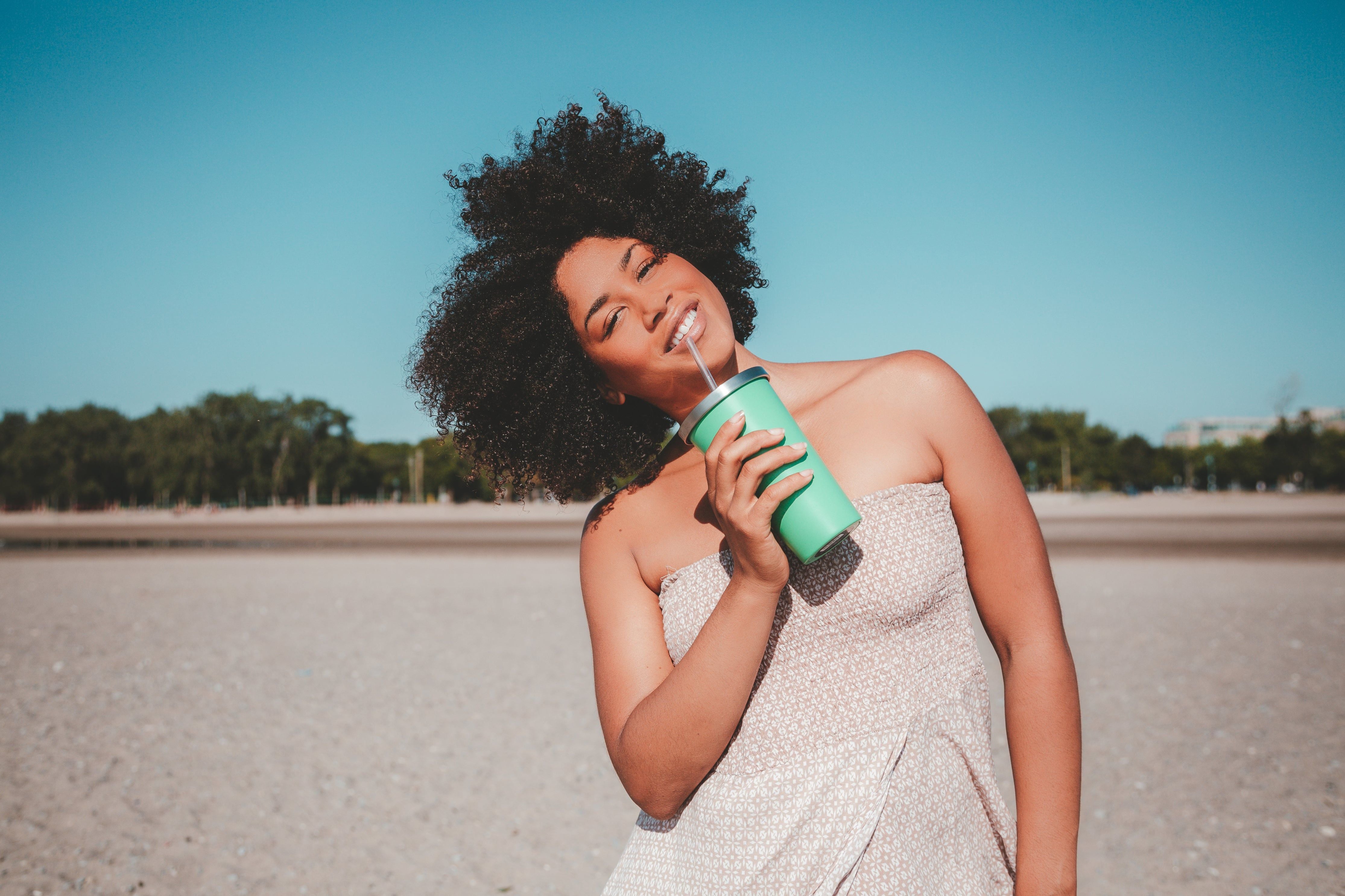 a brunette girl with moisturized curly deifined hair.