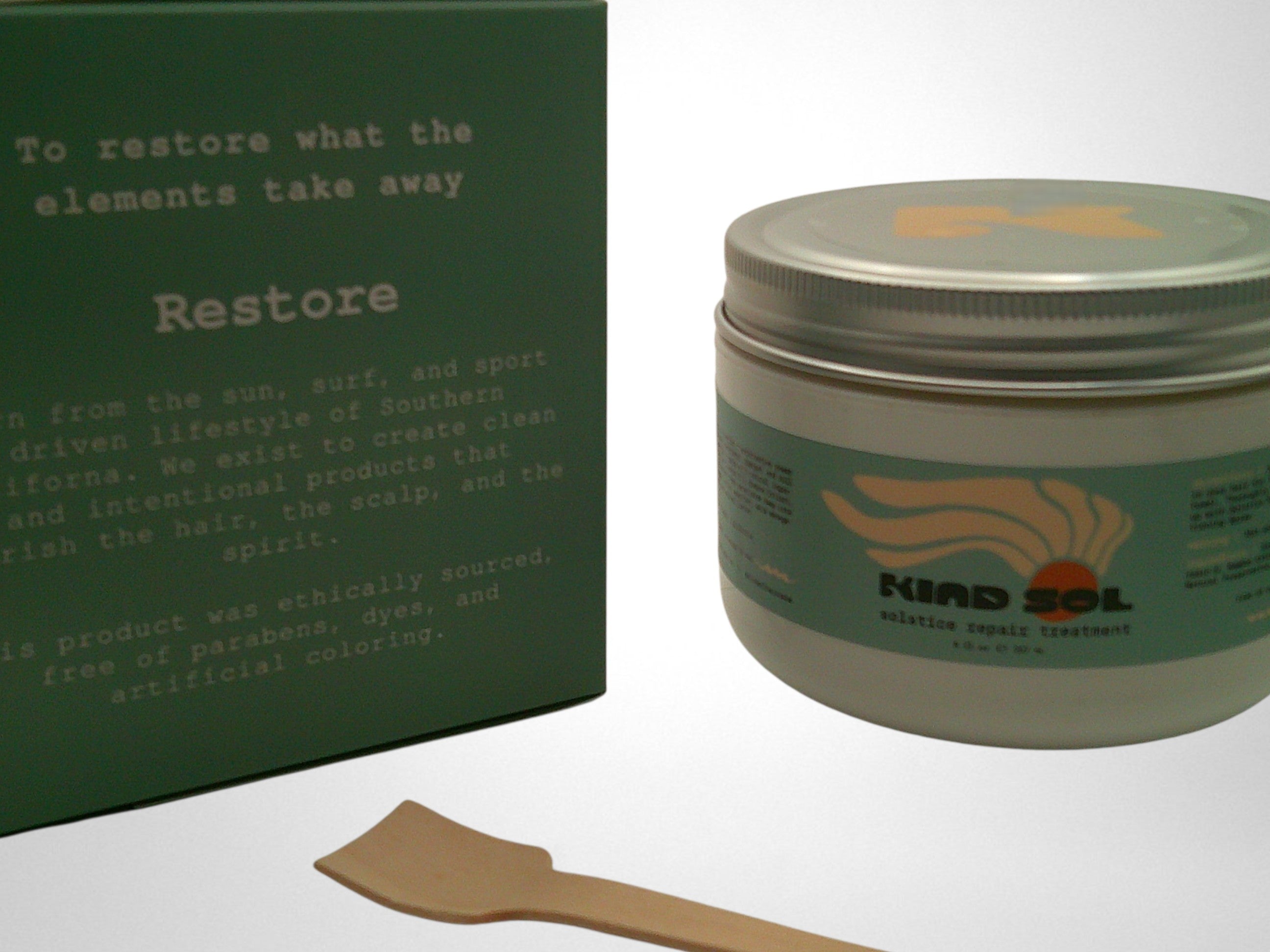 Tin container with a wooden applicator and green box on a white background